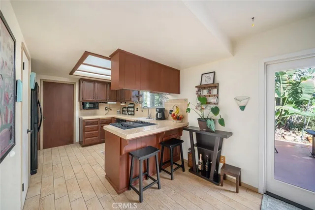 a kitchen with stainless steel appliances a sink stove and refrigerator
