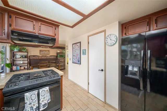 a kitchen with stainless steel appliances granite countertop a stove and a refrigerator