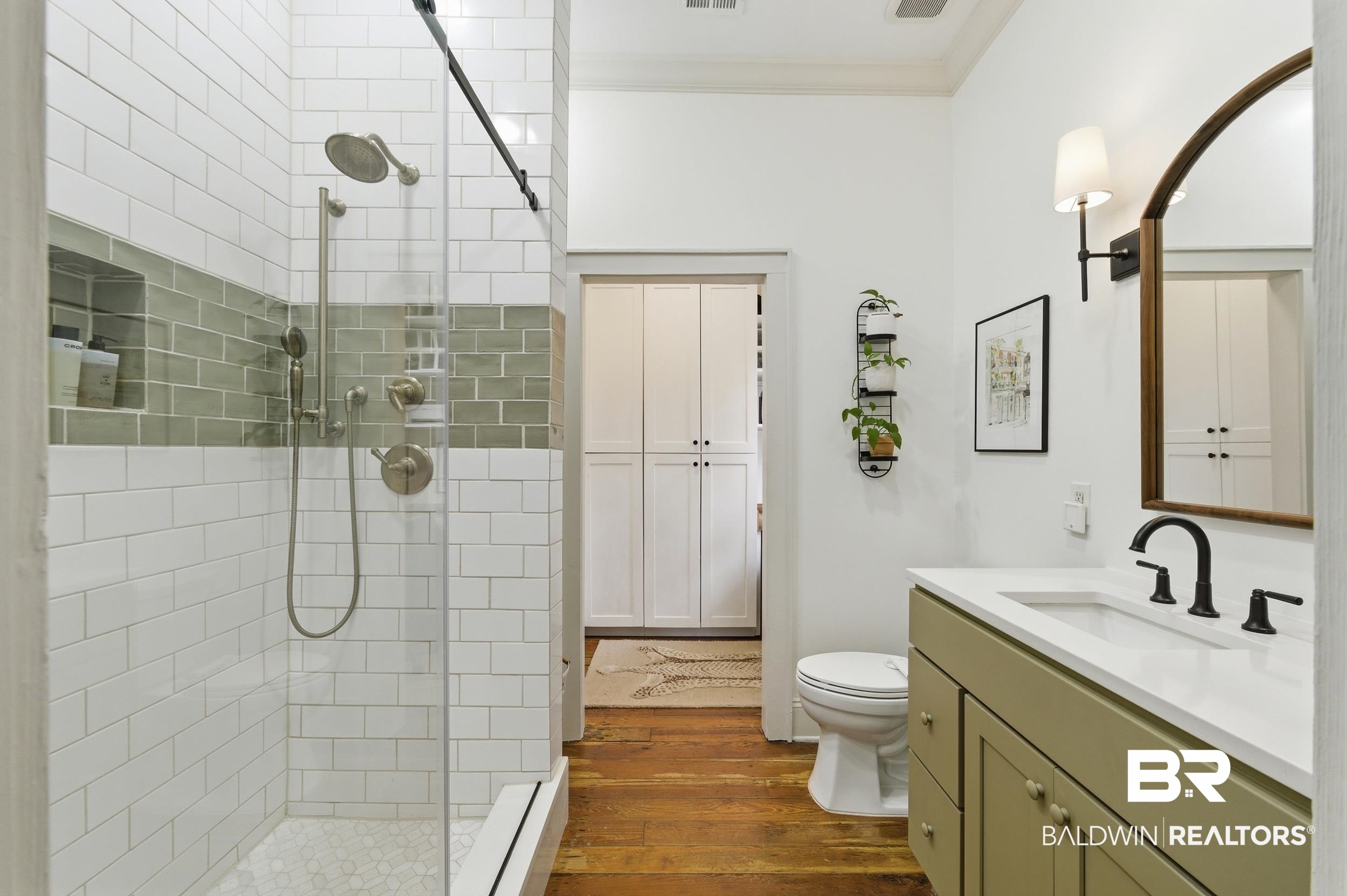 350 Charles Street Mobile, AL 36604 - Photo 19 of 52 Shower featuring white subway tile with a gray accent band, glass enclosure, and brushed nickel fixtures
