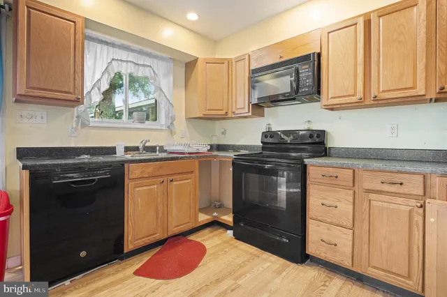 a kitchen with a refrigerator a stove top oven a sink and dishwasher