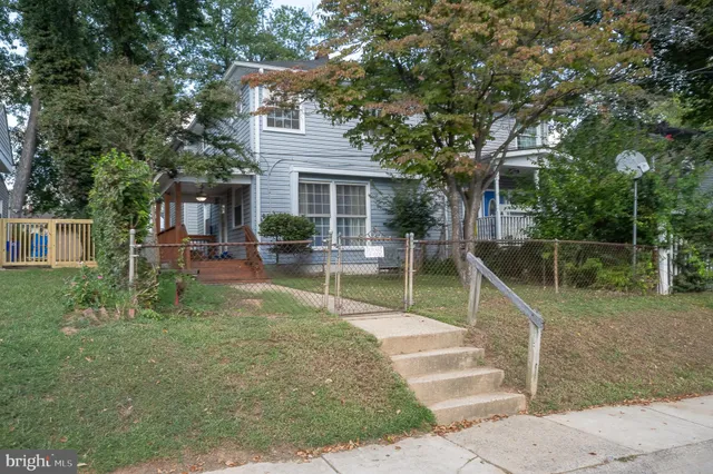 a view of a house with backyard porch and sitting area