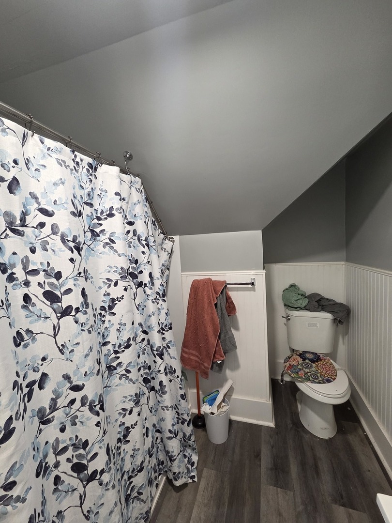 335 6th Avenue North Clinton, IA 52732 - Photo 19 of 23 a bathroom with a toilet and a shower curtain