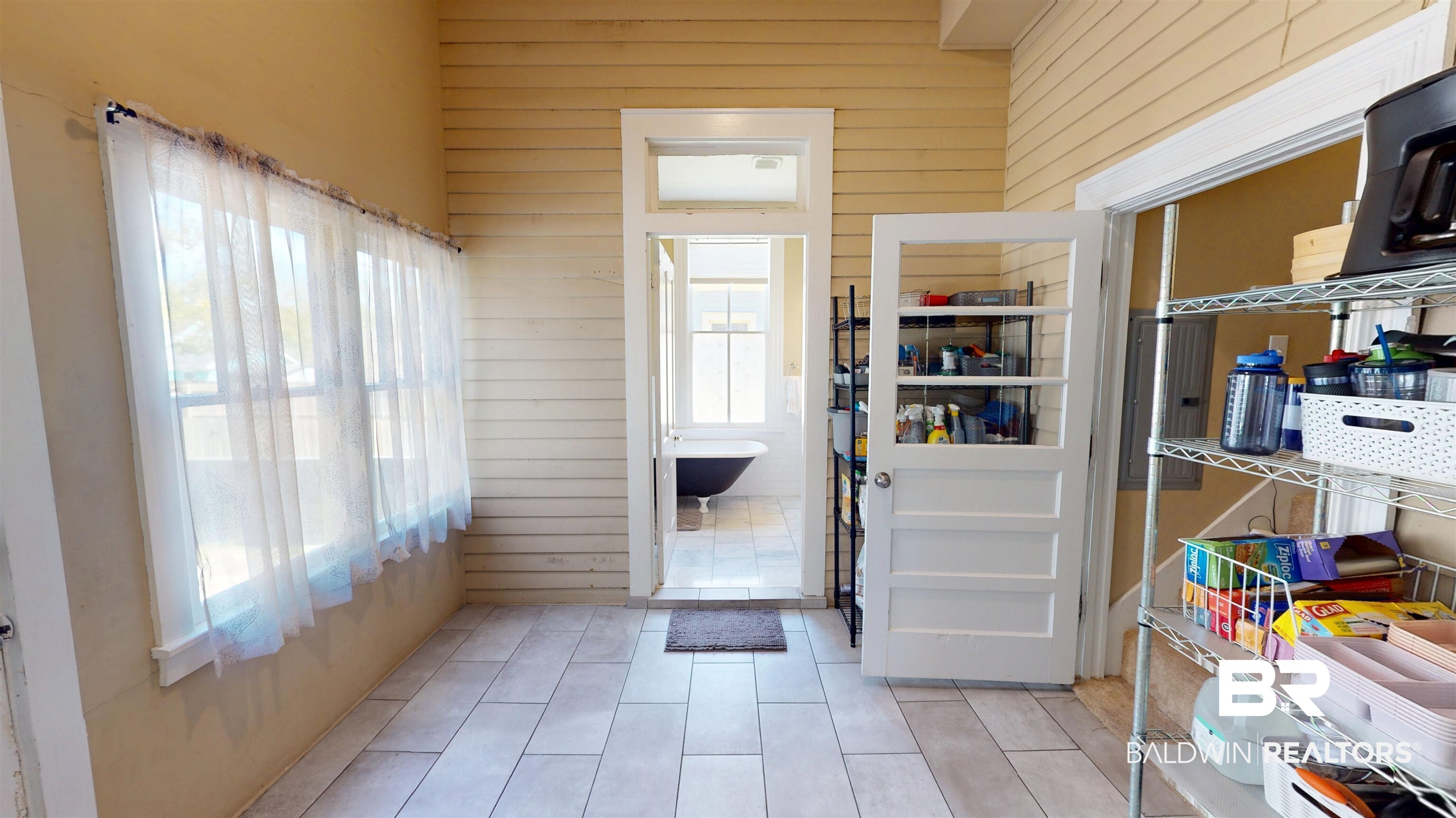 1154 New St Francis Street Mobile, AL 36604 - Photo 18 of 37 Entryway featuring wooden walls, light tile patterned floors, and a wealth of natural light