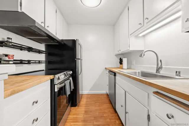 a kitchen with stainless steel appliances a sink and a stove