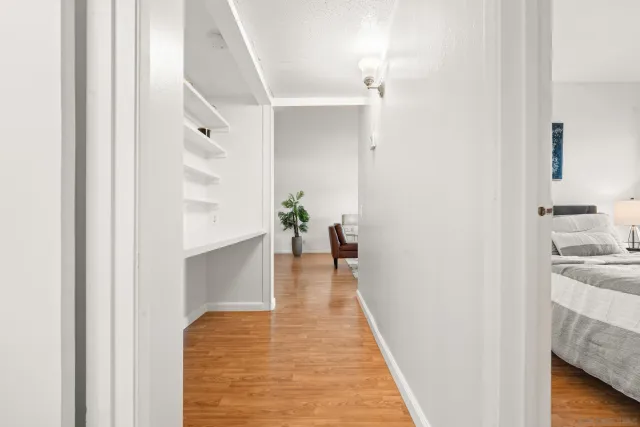 a view of a hallway view with wooden floor and staircase
