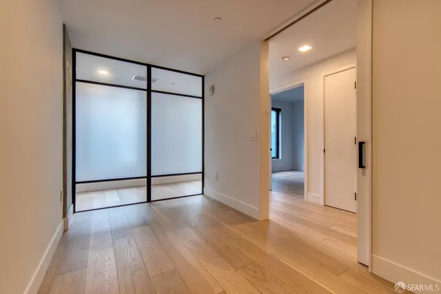 a view of kitchen with stainless steel appliances granite countertop cabinets and wooden floor