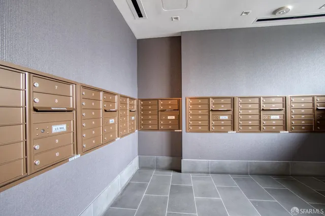 a view of an empty room with window and cabinet