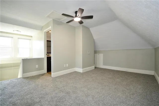 an empty room with closet and windows