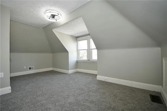 an empty room with windows and painted walls