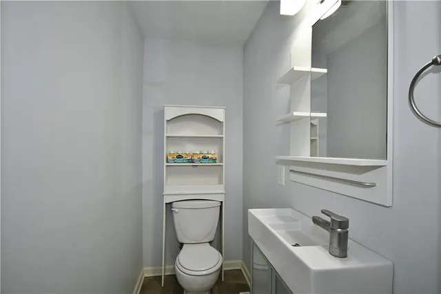 a white toilet sitting next to a bathroom sink