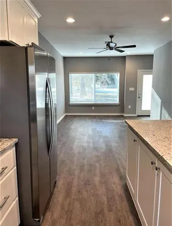 a view of a refrigerator in kitchen and wooden floor