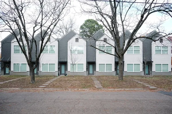a front view of a building with trees