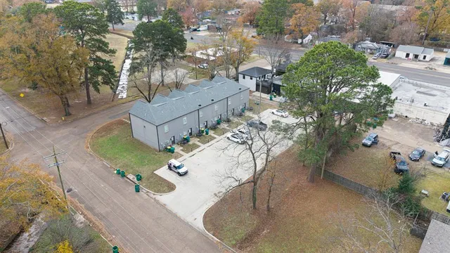 an aerial view of a house with a yard