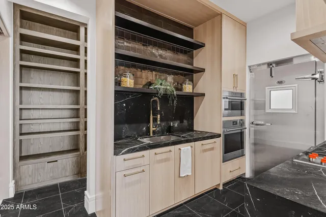 a kitchen with a refrigerator and cabinets