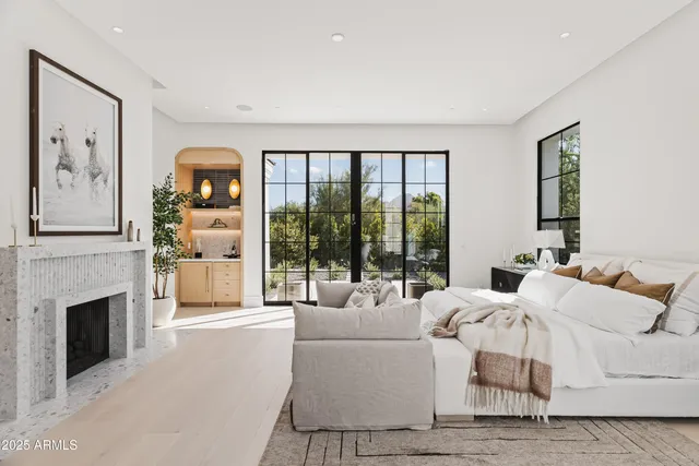 a living room with furniture a large window and a fireplace