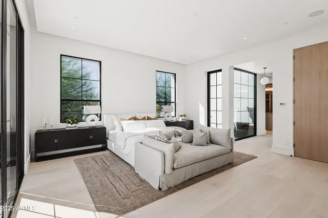 a bedroom with a large bed and a fireplace