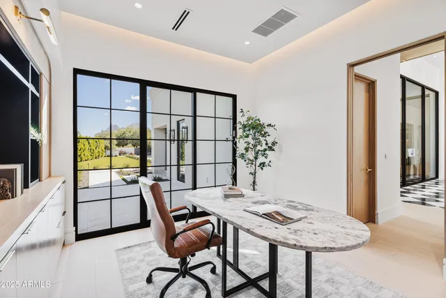 an empty room with windows and closet