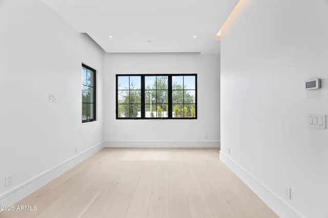 a view of a dining room with furniture a chandelier and wooden floor