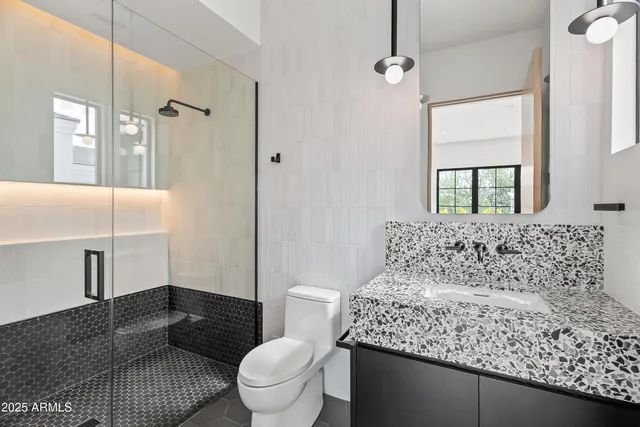 a living room with furniture and potted plants