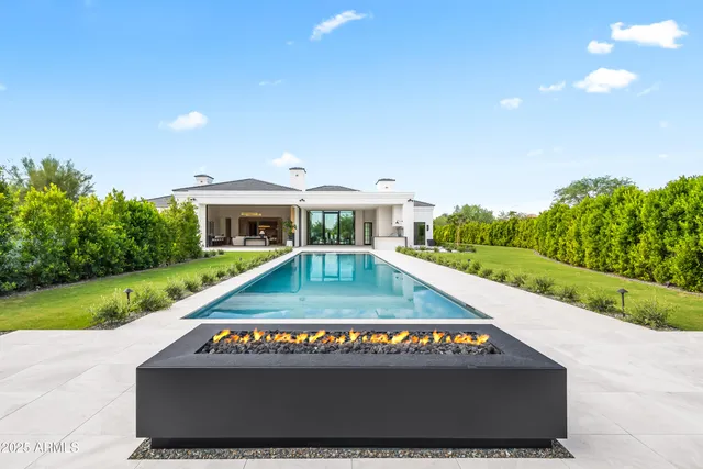 a living room with furniture and a mirror