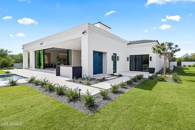 an aerial view of residential houses with outdoor space and street view