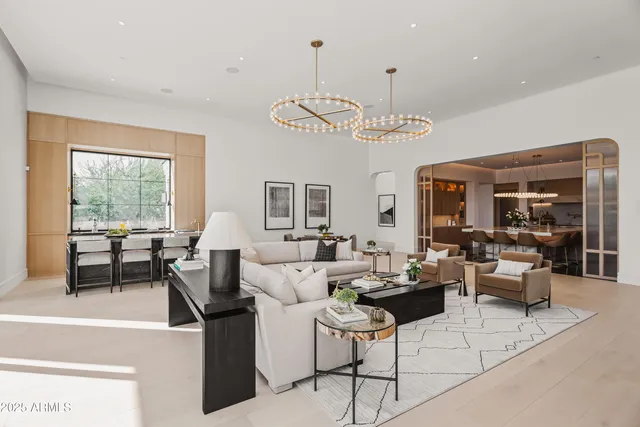 a living room with lots of furniture and a chandelier