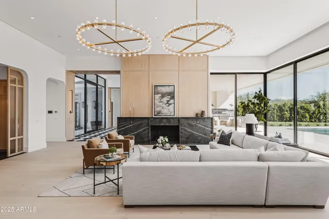 a living room with furniture and floor to ceiling window