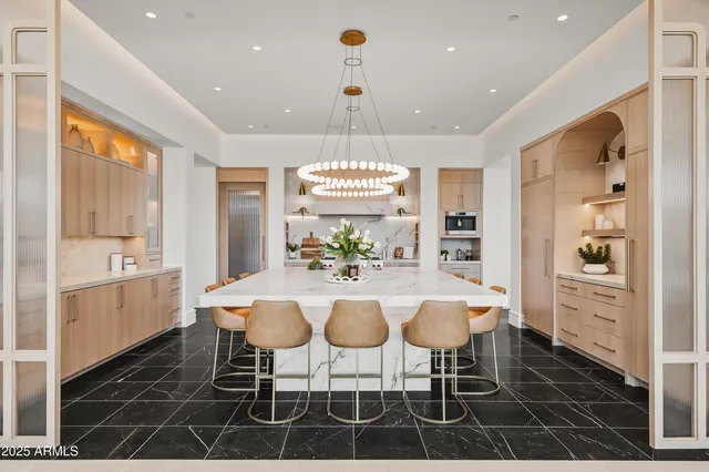a view of a dining room with furniture and chandelier