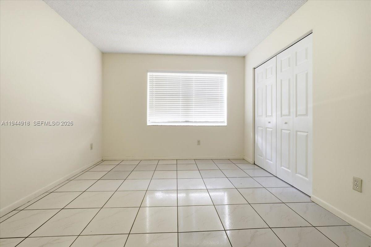 14861 Southwest 104th Street, Unit 2813 Miami, FL 33196 - Photo 16 of 21 a view of an empty room with a window