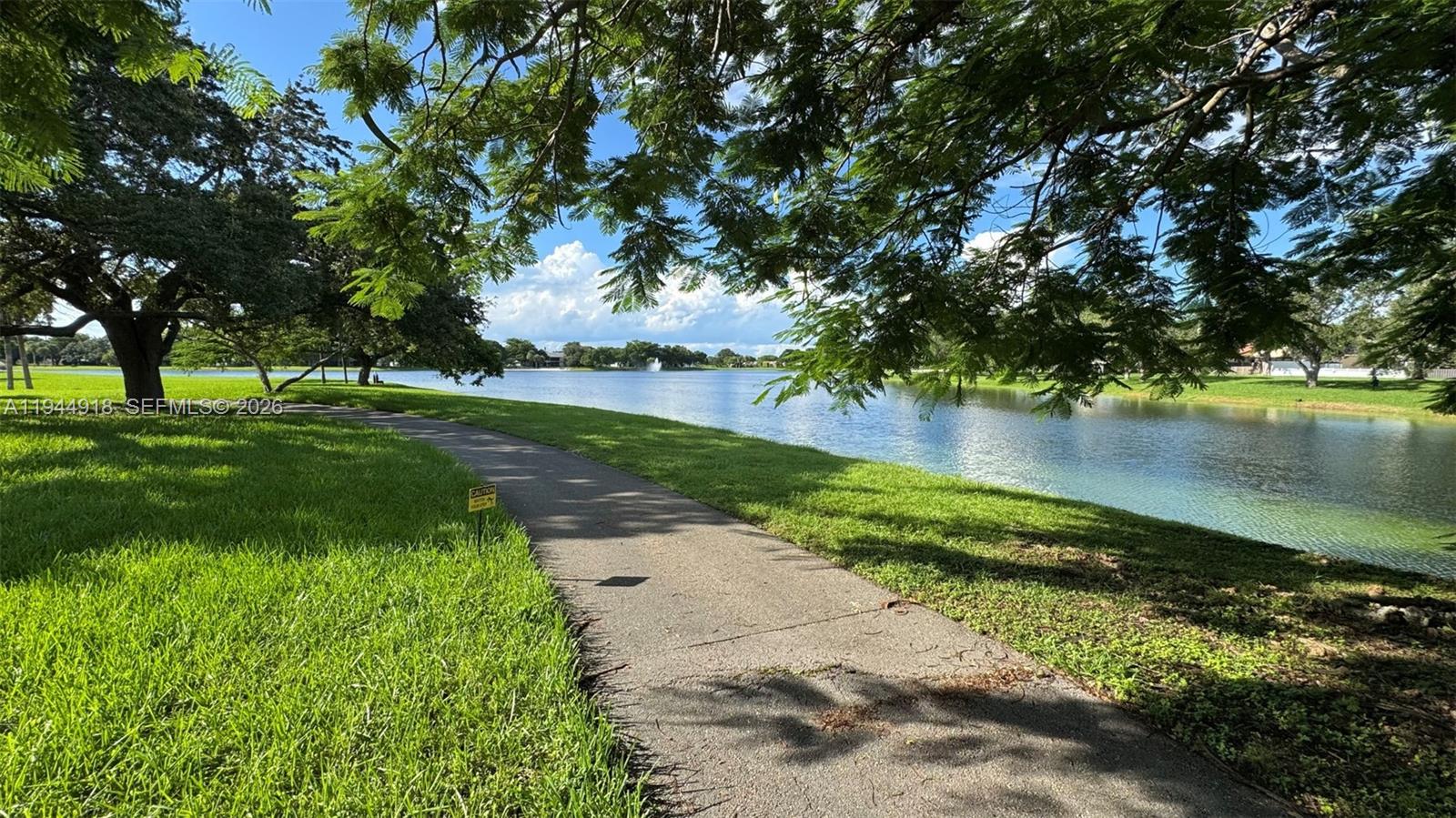 14861 Southwest 104th Street, Unit 2813 Miami, FL 33196 - Photo 21 of 21 a view of a lake with a yard