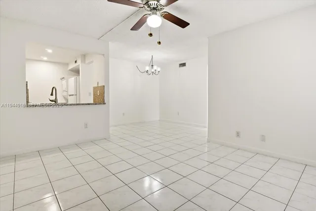 a view of a kitchen with marble wall and chandelier