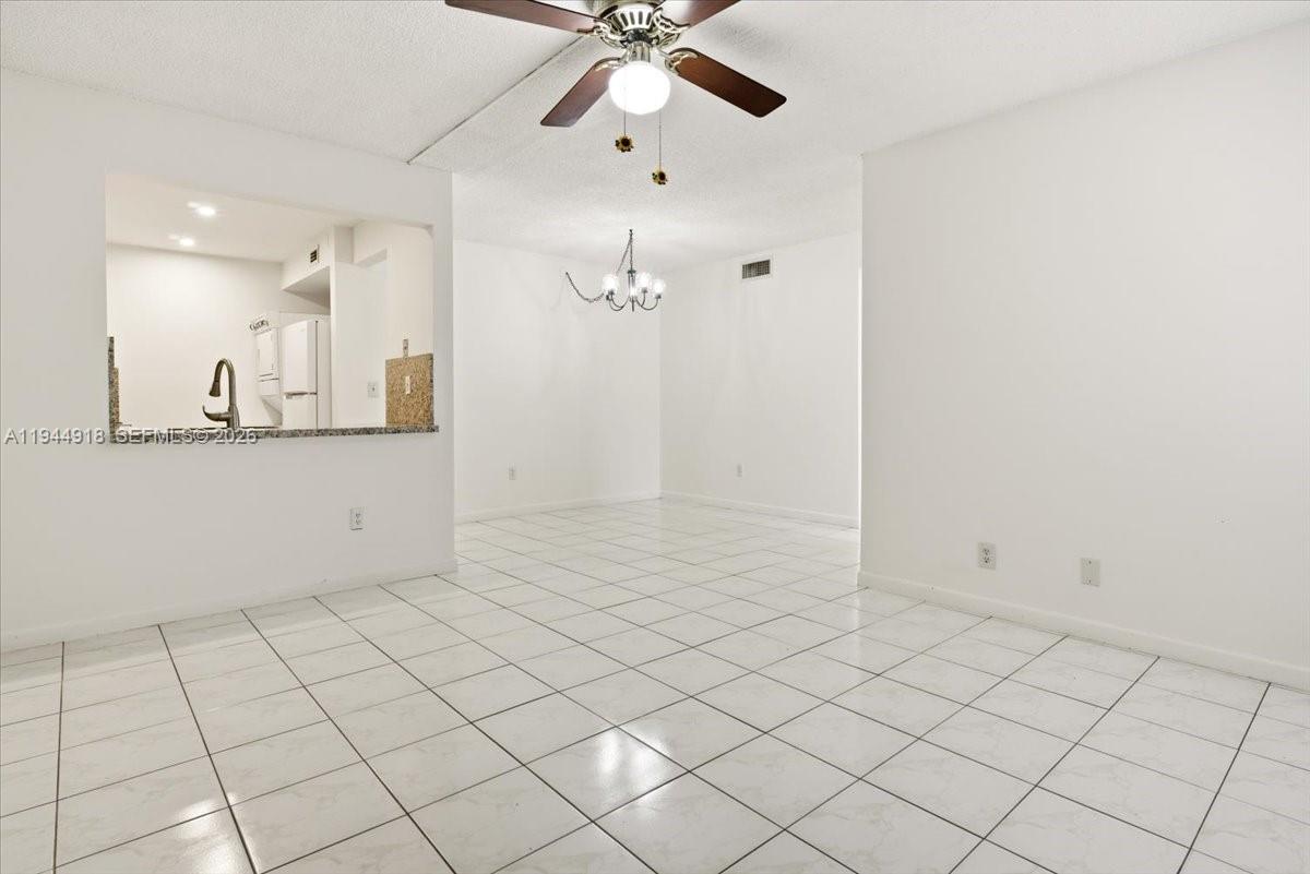 14861 Southwest 104th Street, Unit 2813 Miami, FL 33196 - Photo 4 of 21 a view of a kitchen with marble wall and chandelier