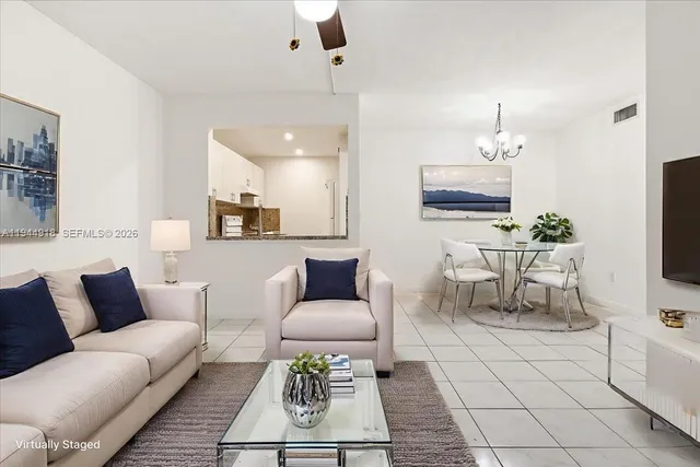 a living room with furniture a rug and a flat screen tv