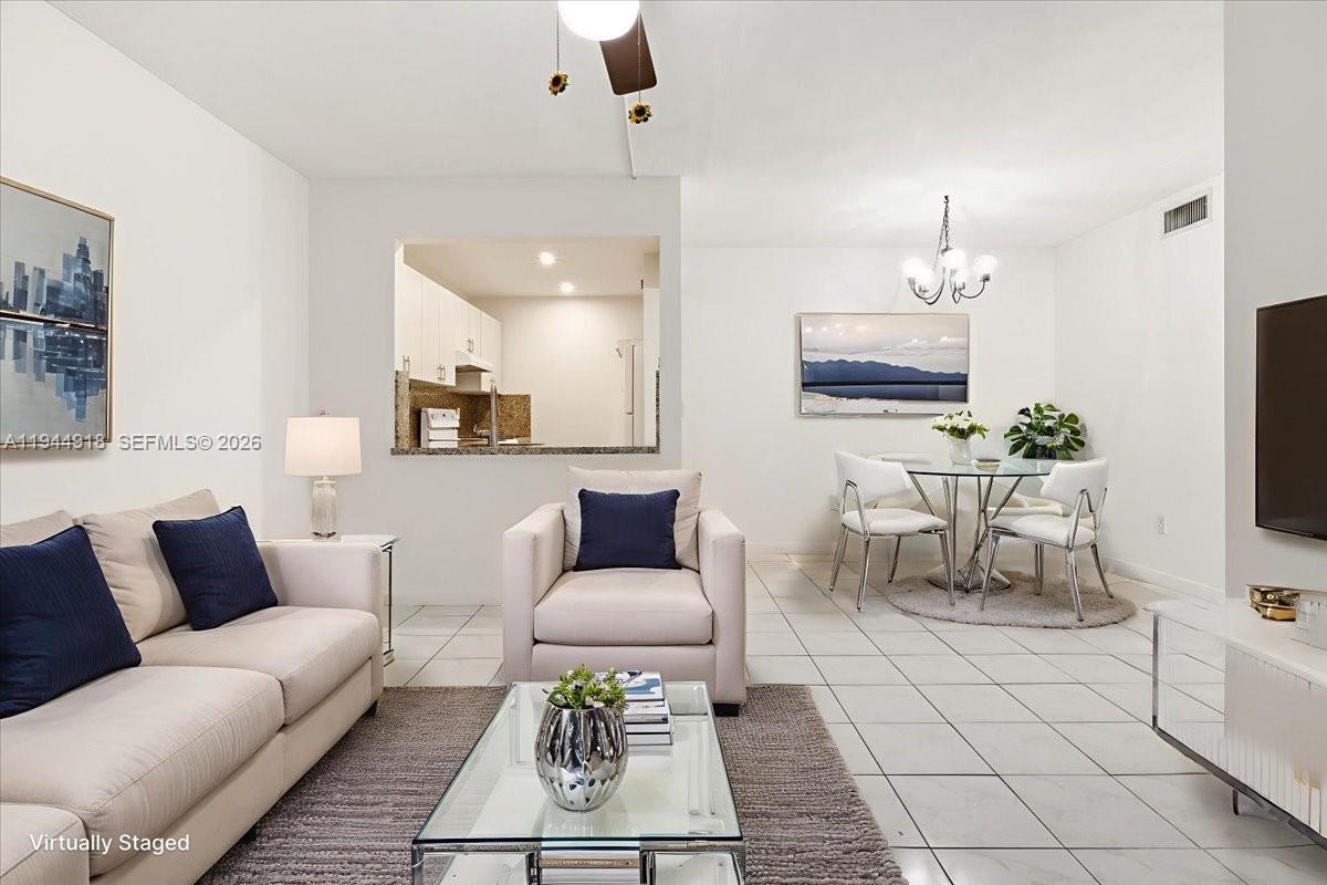 14861 Southwest 104th Street, Unit 2813 Miami, FL 33196 - Photo 6 of 21 a living room with furniture a rug and a flat screen tv