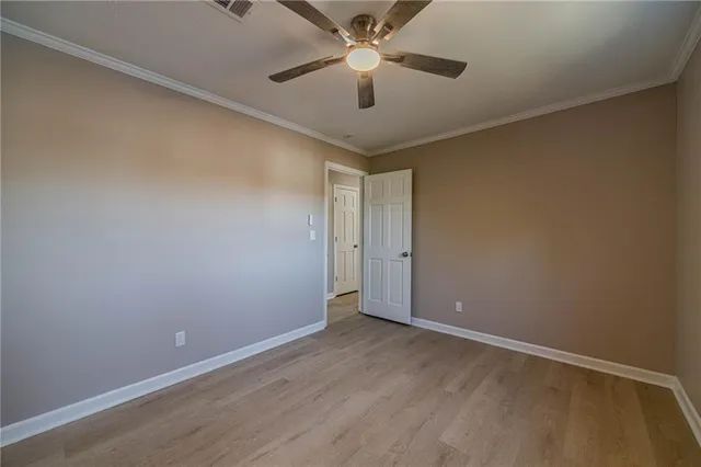 an empty room with a ceiling fan and a ceiling fan