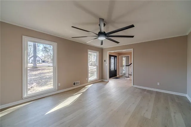 wooden floor in an empty room with a window
