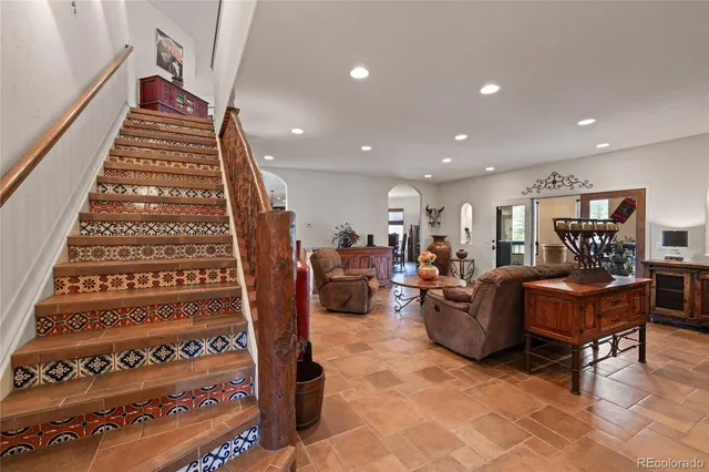 a living room with furniture and a piano