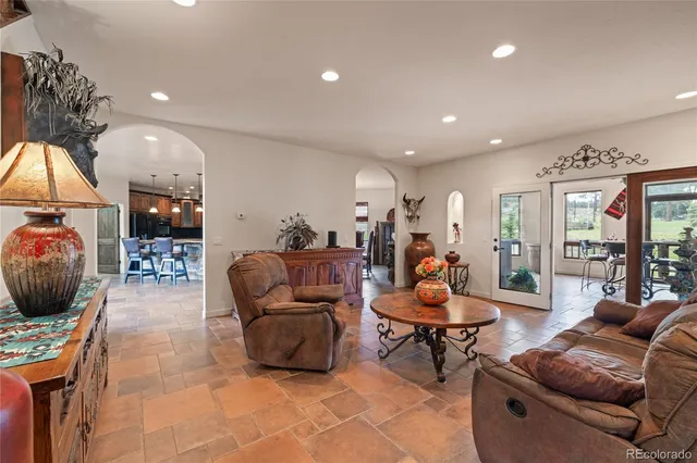 a living room with furniture a window and a flat screen tv