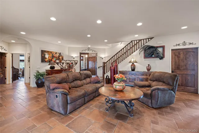 a living room with furniture kitchen view and a table