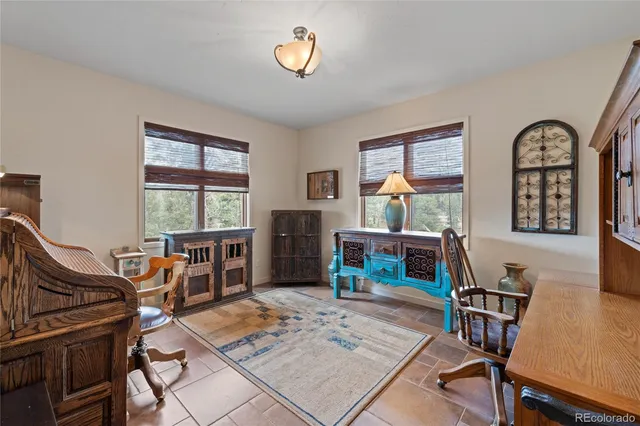 a living room with furniture a window and a flat screen tv