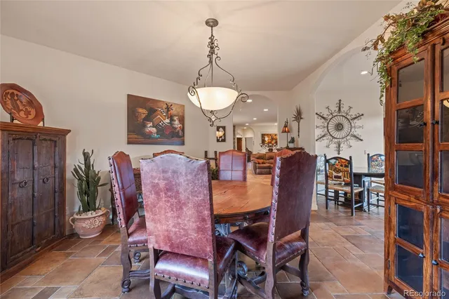 a view of a dining room with furniture and chandelier
