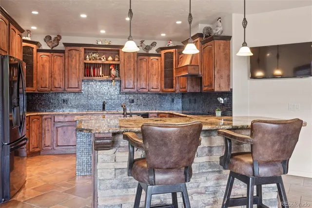 a kitchen with a table chairs sink and cabinets