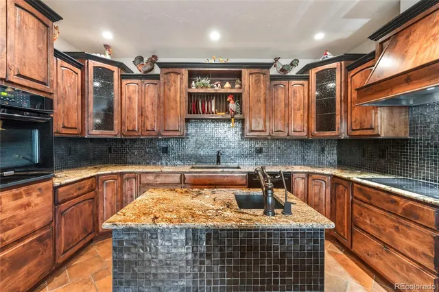 a kitchen with stainless steel appliances granite countertop a sink and cabinets