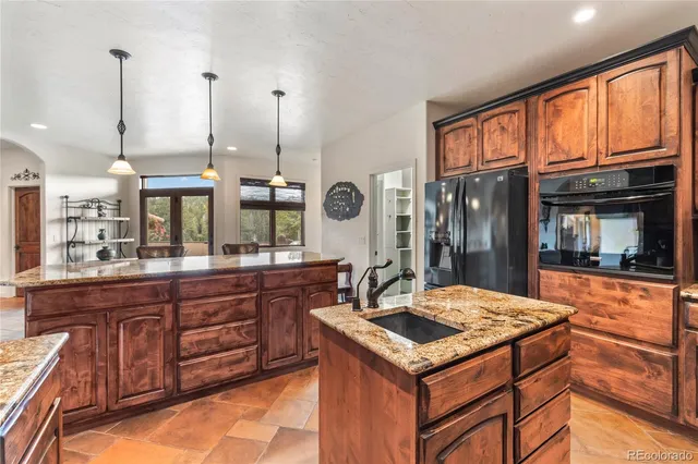 a kitchen with a stove and a wooden cabinets