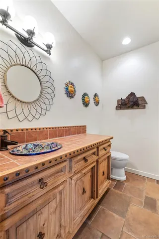 a bathroom with a toilet a sink and a mirror