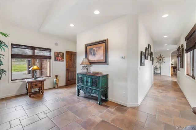 a view of a hallway with a furniture and a livingroom