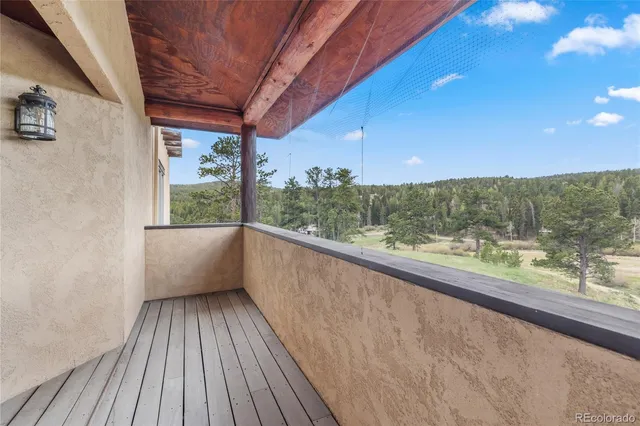 a view of a balcony with furniture and wooden floor