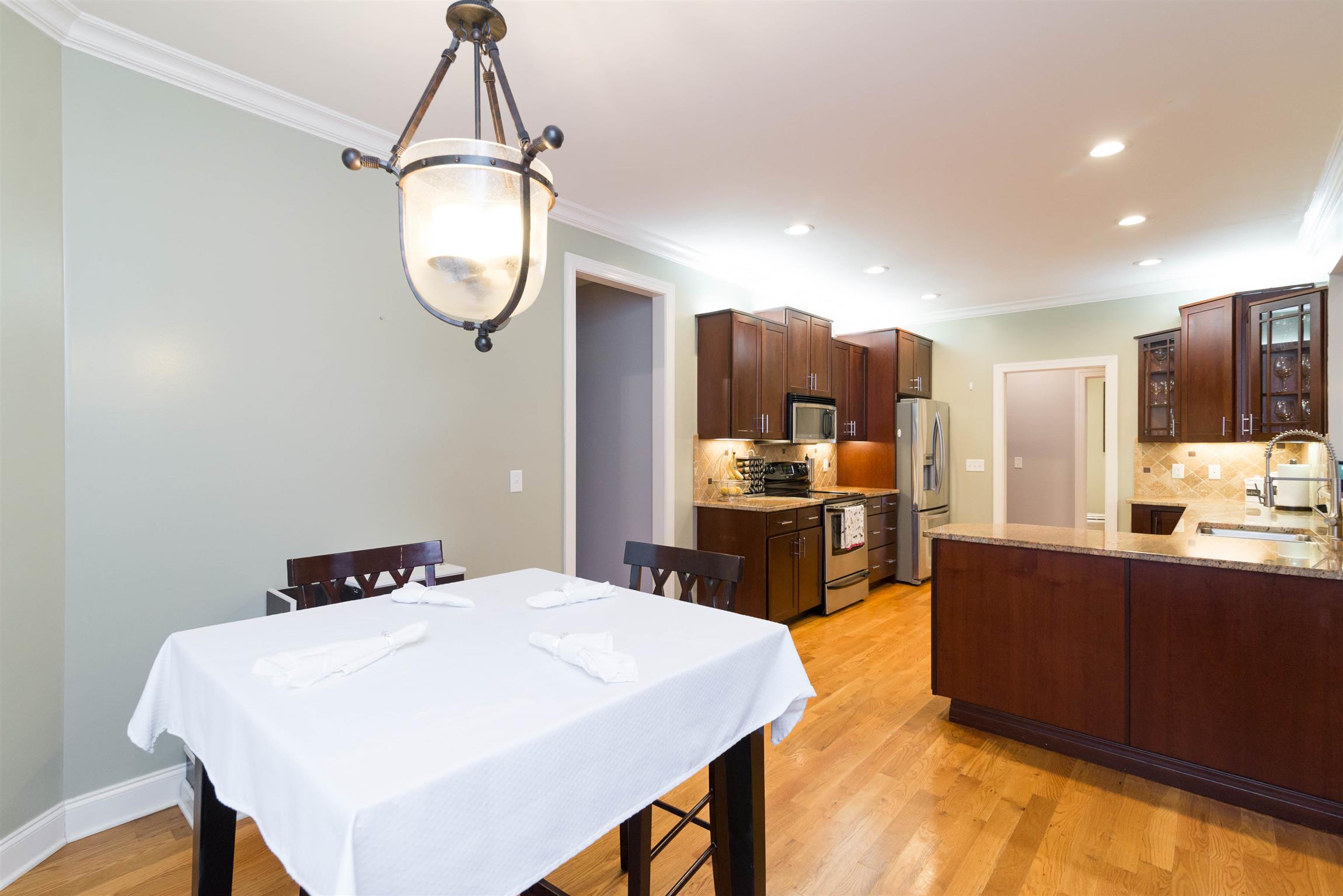 623 Tulip Grove Road Hermitage, TN 37076 - Photo 11 of 30 a kitchen with stainless steel appliances a stove a refrigerator a sink dishwasher with a dining table and chairs