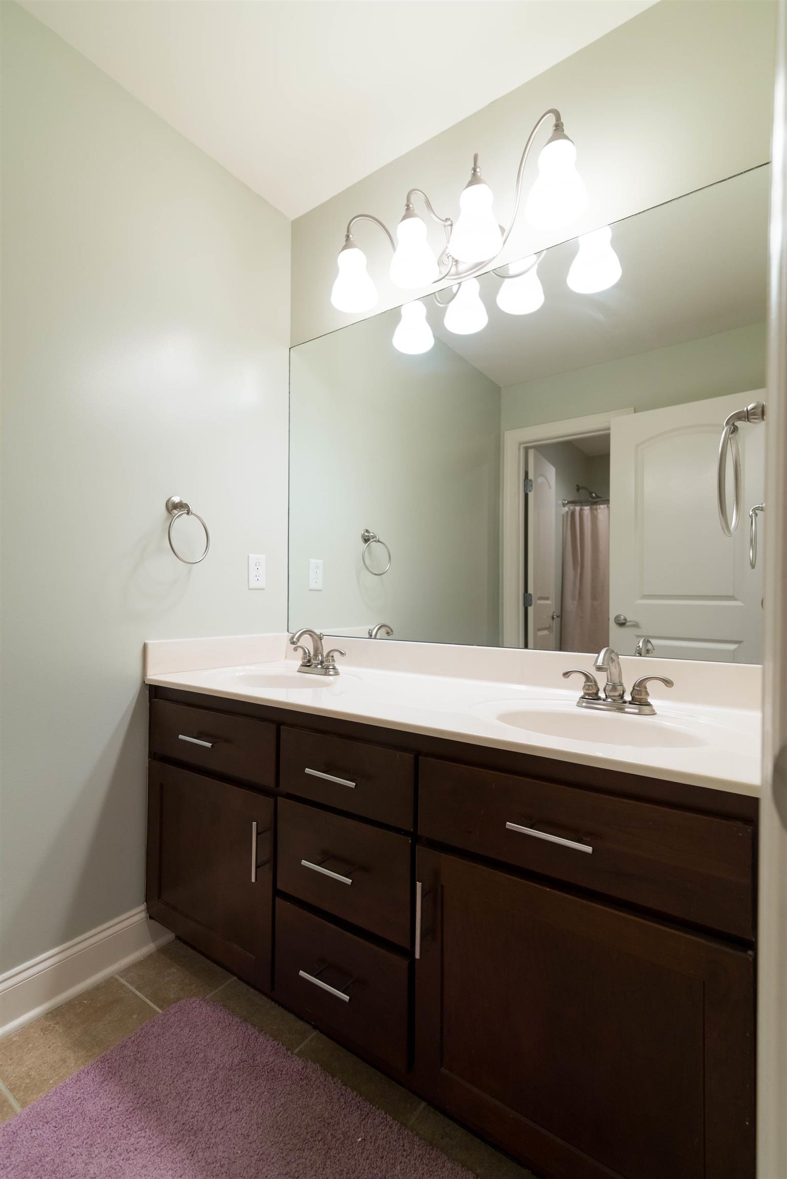 623 Tulip Grove Road Hermitage, TN 37076 - Photo 23 of 30 a bathroom with a sink and a mirror