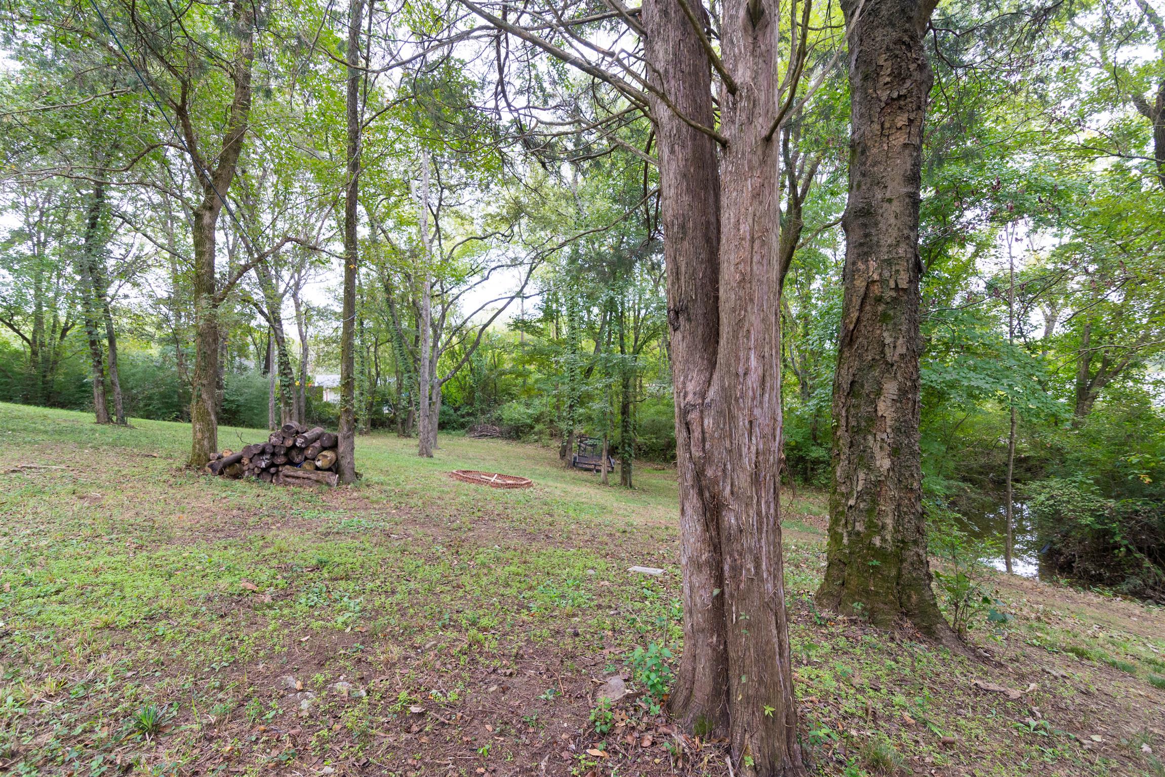 623 Tulip Grove Road Hermitage, TN 37076 - Photo 30 of 30 a view of a backyard with large trees and wooden fence